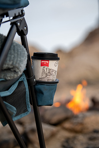 Maverik cup in cup holder on side of camp chair